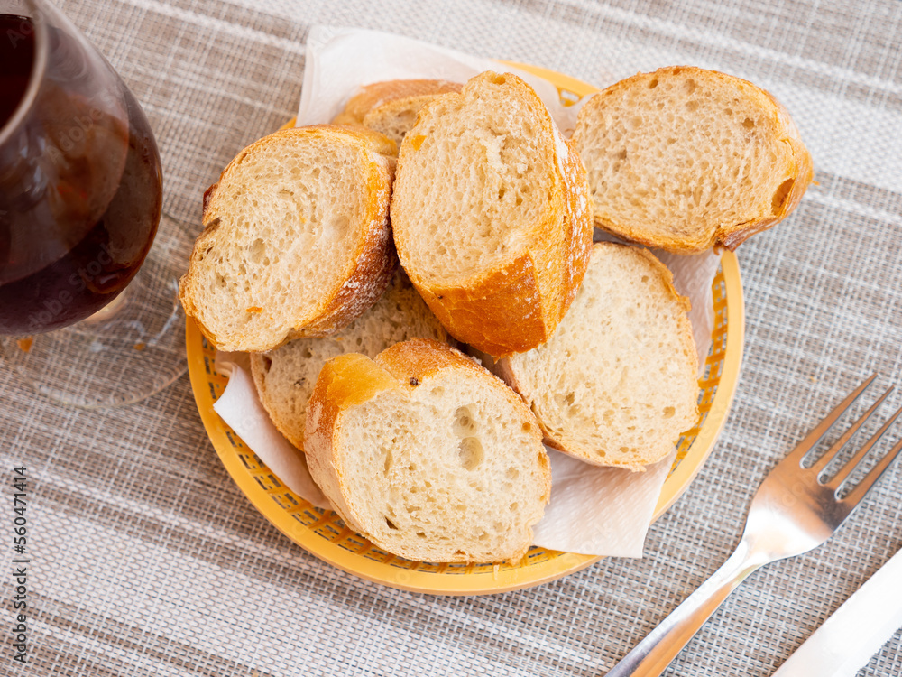 Closeup of fresh spanish bread served in a basket on a table in a restaurant