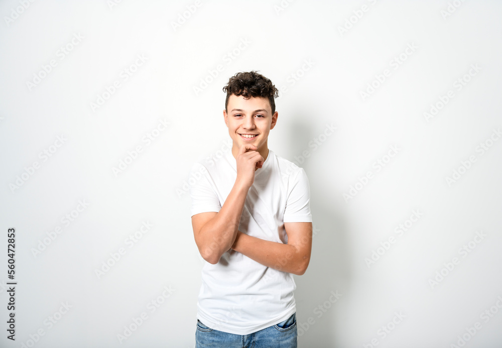 White t-shirt on teen boy. Handsome pensive caucasian isolated on a white background White t-shirt on teen boy. Handsome pensive caucasian isolated on a white background