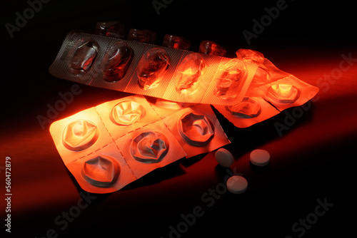 Fotografie Two empty blister pack with pills, illuminated with red color