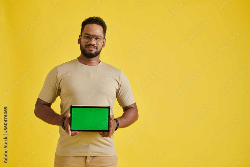 Portrait of joyful man showing digital tablet with green screen Portrait of joyful man showing digital tablet with green screen