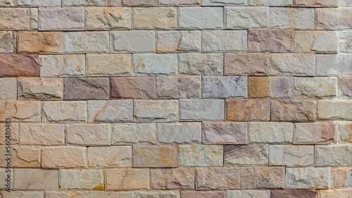 The stone wall texture background natural color. Background of stone wall texture photo. Natural stone wall texture for background. Old Brick  texture  Grunge brick wall background.