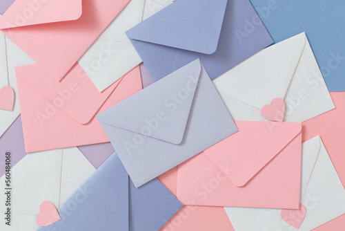 Full frame overhead view of assorted pastel coloured envelopes and heart shaped stickers photo