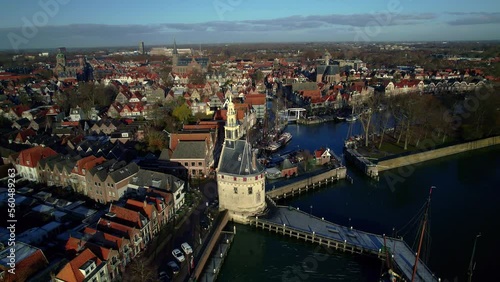 Aerial view Establishing shot Historic Hoofdtoren tower in a dutch idyllic old harbor of the city of Hoorn, old streets, moored sailing boats on the quay. In North Holland, Netherlands Lake Markermeer