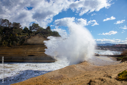 Cloudy and windy weather with large waves at the beach in Peroulades, north Corfu island, Greece