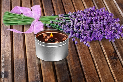 Beautiful aroma candle with fresh flowers photo