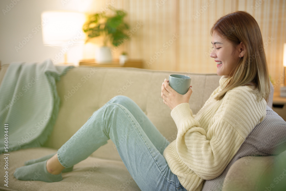Asian girl drinking coffee at home in the morning