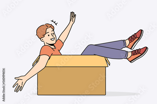 Smiling boy have fun sitting in cardboard box. Happy young man in carton package excited about moving or relocation. Vector illustration. 