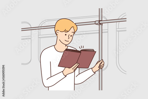 Man riding in bus reading book 