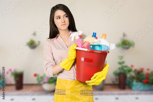 Young cleaner woman working at home or hotel