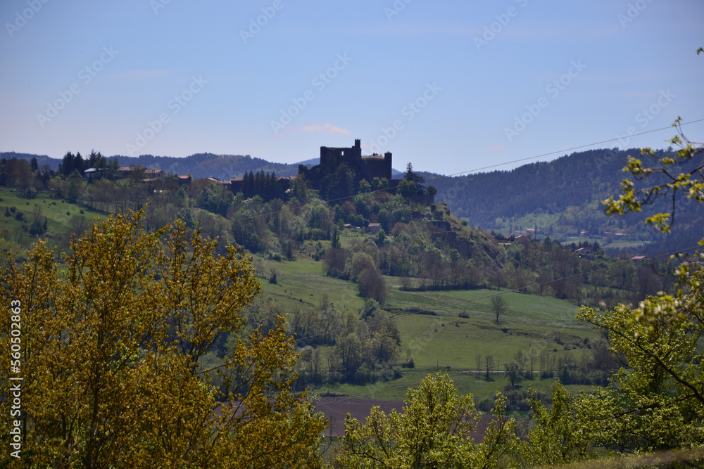 Le Puy-en-Velay, France - May 5th 2019 : The Château de Bouzols, an old fortified castle, whose origins date back to the 9th century. It's a stone castle that looks like a dark fortress in nature.