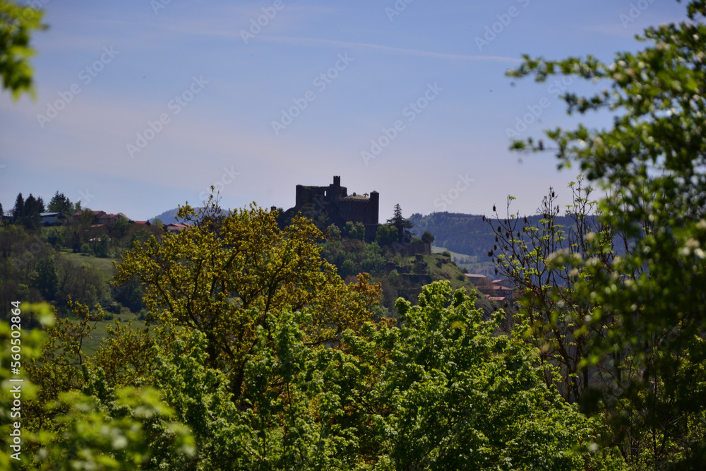 Le Puy-en-Velay, France - May 5th 2019 : The Château de Bouzols, an old fortified castle, whose origins date back to the 9th century. It's a stone castle that looks like a dark fortress in nature.