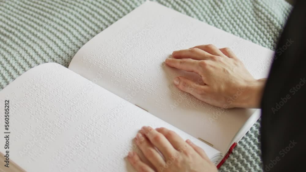 Poorly seeing woman learning Braille book. A person with blindness touches and reads with his hands. Poorly seeing woman learning Braille book. A person with blindness touches and reads with his hands.