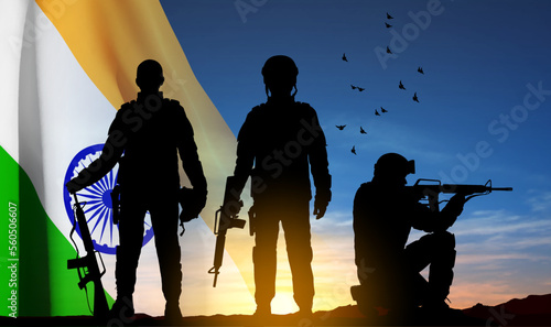 Silhouettes of soldiers with India flag on a background the sunset. Concept for National Holidays. EPS10 vector