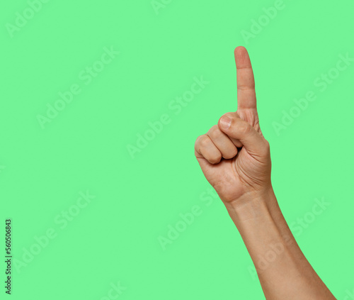 Index finger raised up isolated on green screen background..