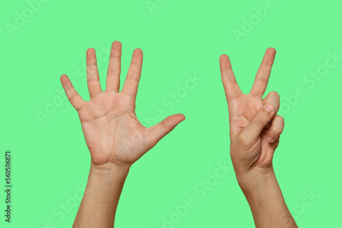 Hands showing number 7 isolated on green screen background.. © glebchik