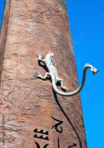 Sculpture of a lizard with another head on its tail, the detail of the sundial in Florence.