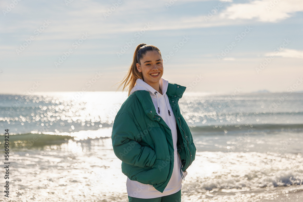 A young athletic girl against the backdrop of the sea