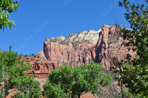 Red Rock Mountain just past green trees
