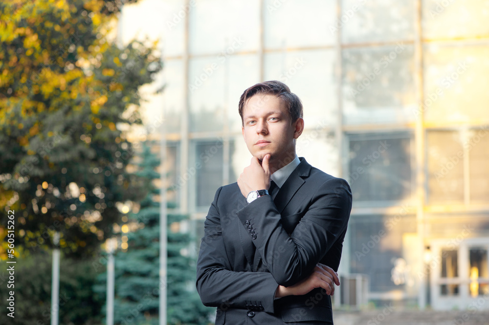 In search of the new ideas. Thoughtful young man in formalwear holding hand on chin and looking away against building structure In search of the new ideas. Thoughtful young man in formalwear holding hand on chin and looking away against building structure