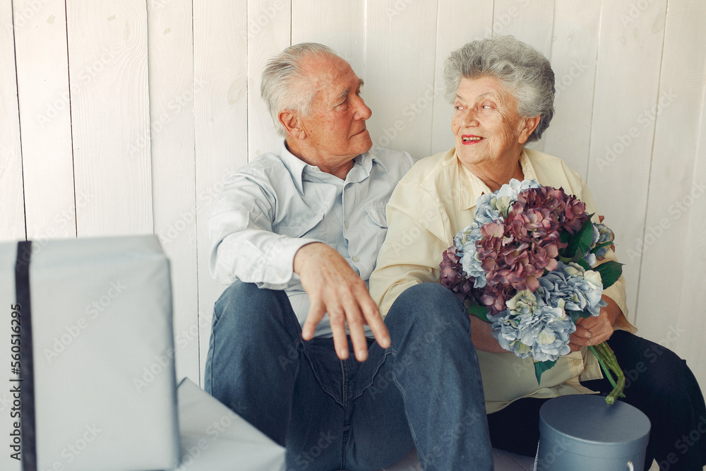 Elegant old couple sitting at home on a foor Elegant old couple sitting at home on a foor