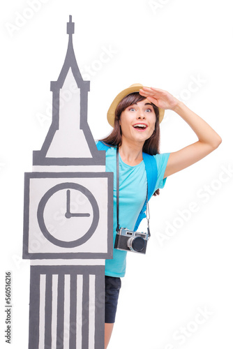 Surching for adventure. Travel concept. Studio portrait of young woman in hat holding hand on forehead standing near Big Ben Tower symbol. Isolated on white. photo