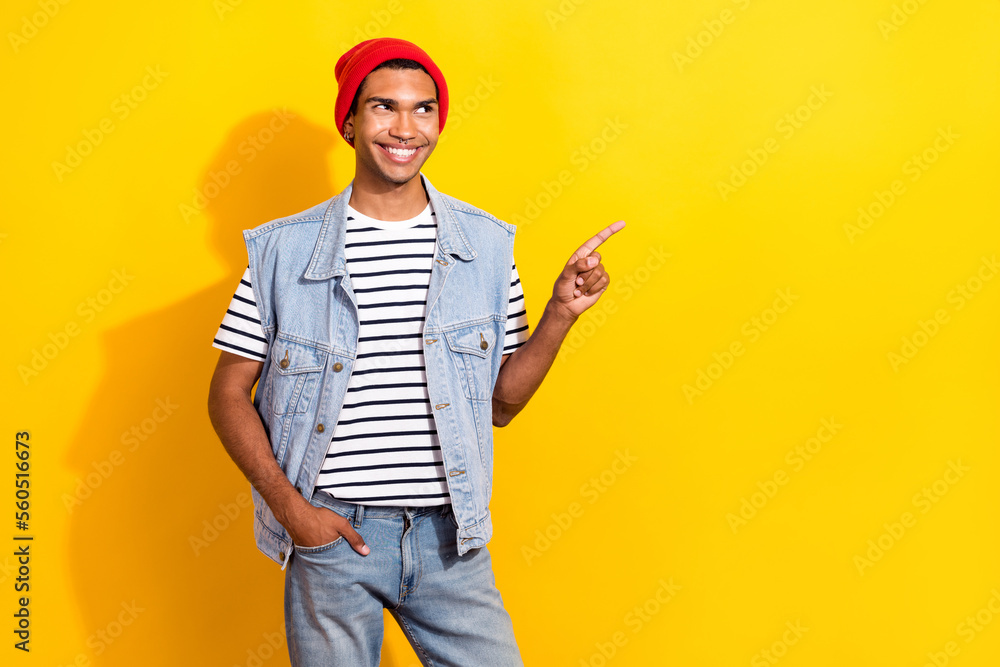 Photo of positive nice man wear denim clothes presenting empty space cool offer special deal isolated on yellow color background Photo of positive nice man wear denim clothes presenting empty space cool offer special deal isolated on yellow color background