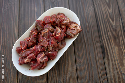 Diced and pickled raw boar meat in spices, open space