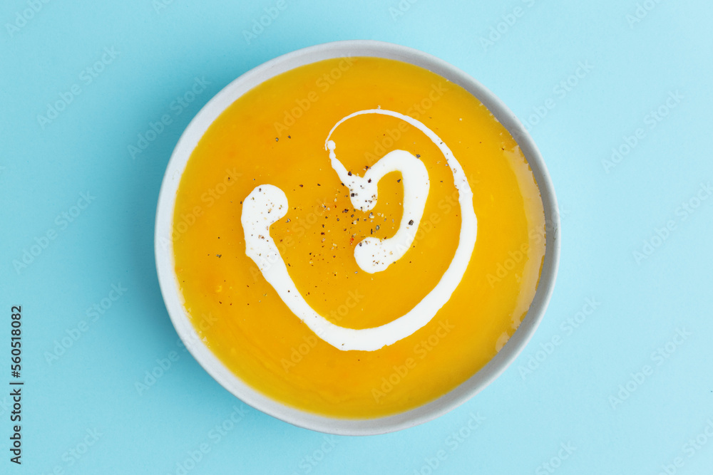 Autumnal soup in bowl on grey background Autumnal soup in bowl on grey background