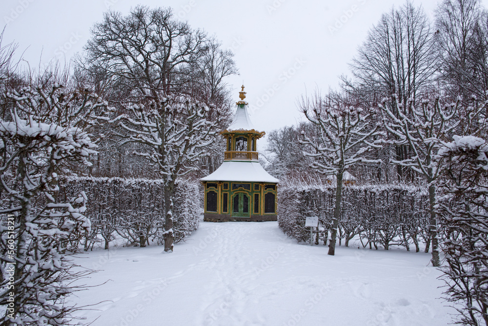 View of Drottningholm Palace gardens in winter. It is the residence of the Swedish royal family and is located near the capital Stockholm, Sweden. The park is covered in snow. View of Drottningholm Palace gardens in winter. It is the residence of the Swedish royal family and is located near the capital Stockholm, Sweden. The park is covered in snow.