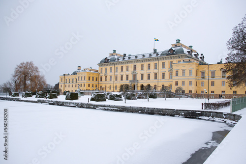 View of Drottningholm Palace from the gardens in winter. It is the residence of the Swedish royal family and is located near the capital Stockholm, Sweden. The park is covered in snow. photo
