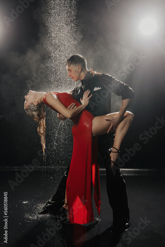 A couple of dancers on a black background in a studio in the aqua zone © Mkorobsky