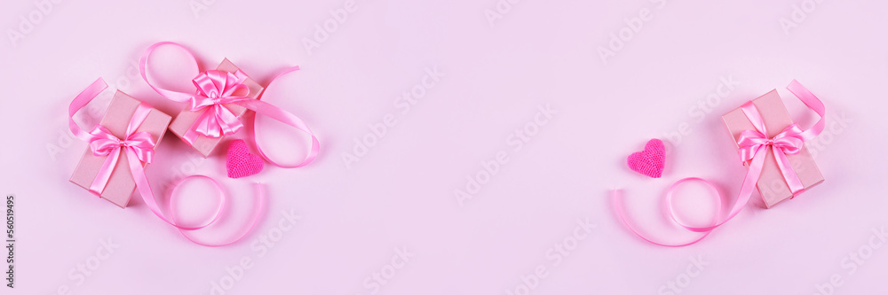 Happy Valentine's Day, Mother's Day and birthday greeting card. Knitted pink heart and gift box with a satin ribbon bow on a pink background. Banner Happy Valentine's Day, Mother's Day and birthday greeting card. Knitted pink heart and gift box with a satin ribbon bow on a pink background. Banner