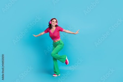 Full length photo of playful pretty positive lady wear stylish summer clothes rejoice weekend empty space isolated on blue color background