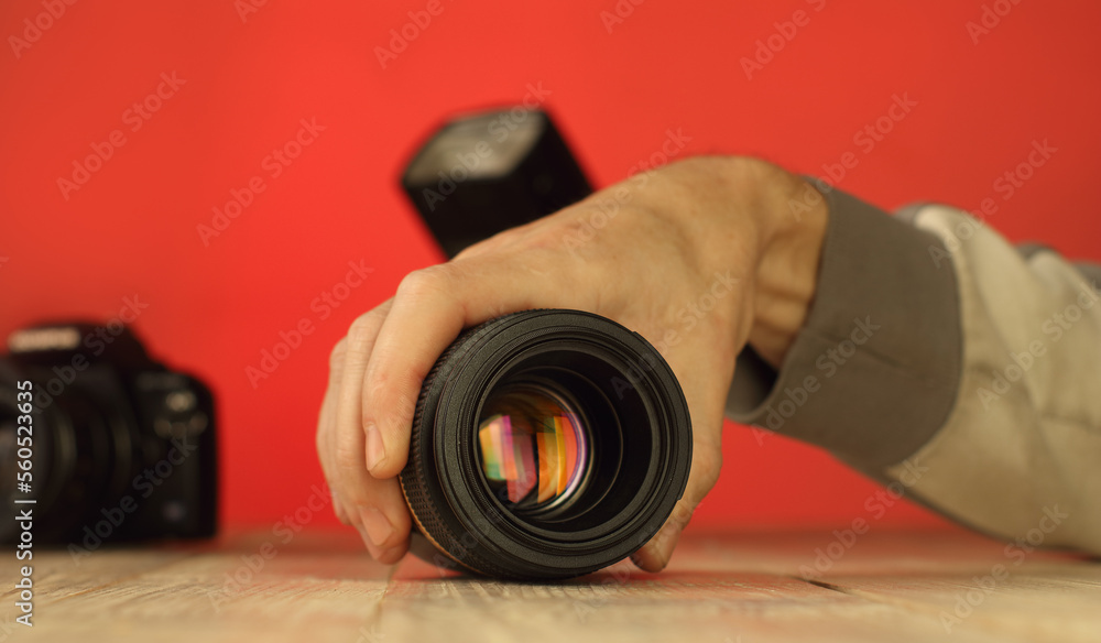 person holding macro lens on table