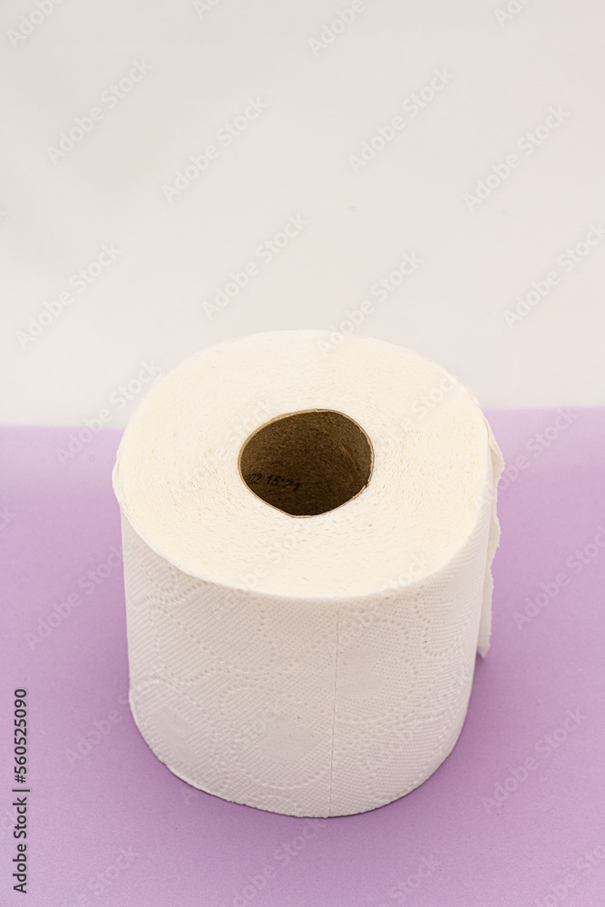 Roll of toilet paper on purple table. Roll of toilet paper on purple table.