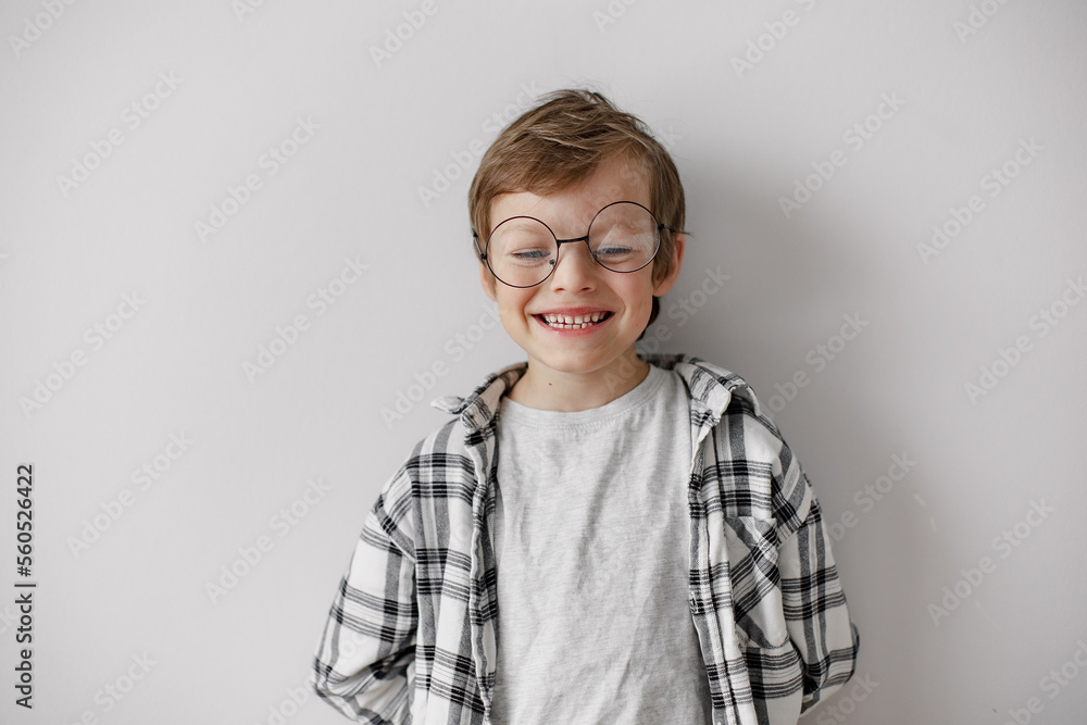 Happy school boy with big smile. Pupil in glasses on grey background. Home education. Happy school boy with big smile. Pupil in glasses on grey background. Home education.