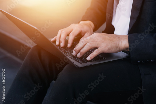 Asian business man and young beautiful woman working on digital tablet computer standing outside office building.