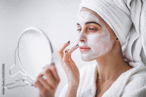 Woman aplying beauty mask,close up photo
