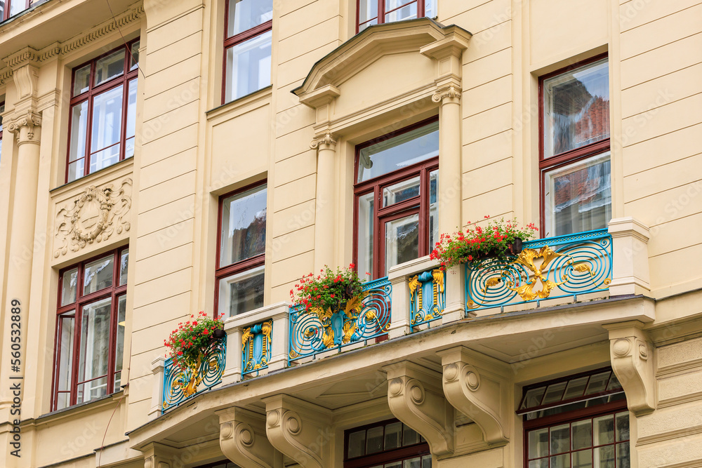 Fototapeta premium Facade of the house of classical European architecture of the old cozy tourist city. Background