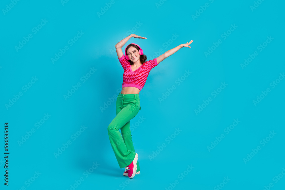Full length photo of cheerful lovely lady wear stylish clothes have fun look empty space device shop isolated on blue color background