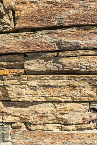 Walls made of multicolor stones. Stone background. Ancient stone wall. Grunge...