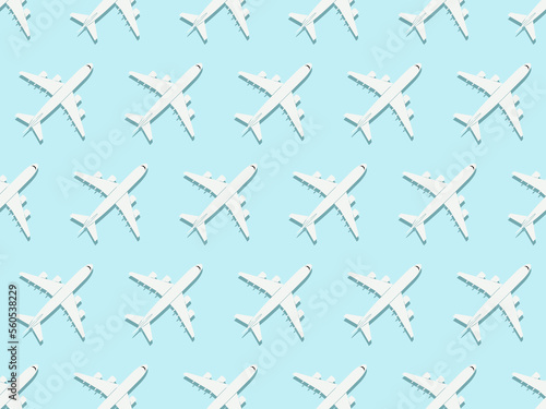 Creative composition made with passenger plane on blue background