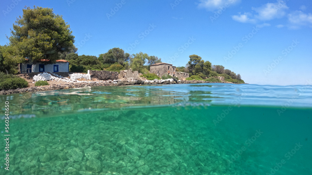 Underwater split photo of famous abandoned seaside houses in small complex islands of Lihadonisia often called Seychelles of Greece, North Evia