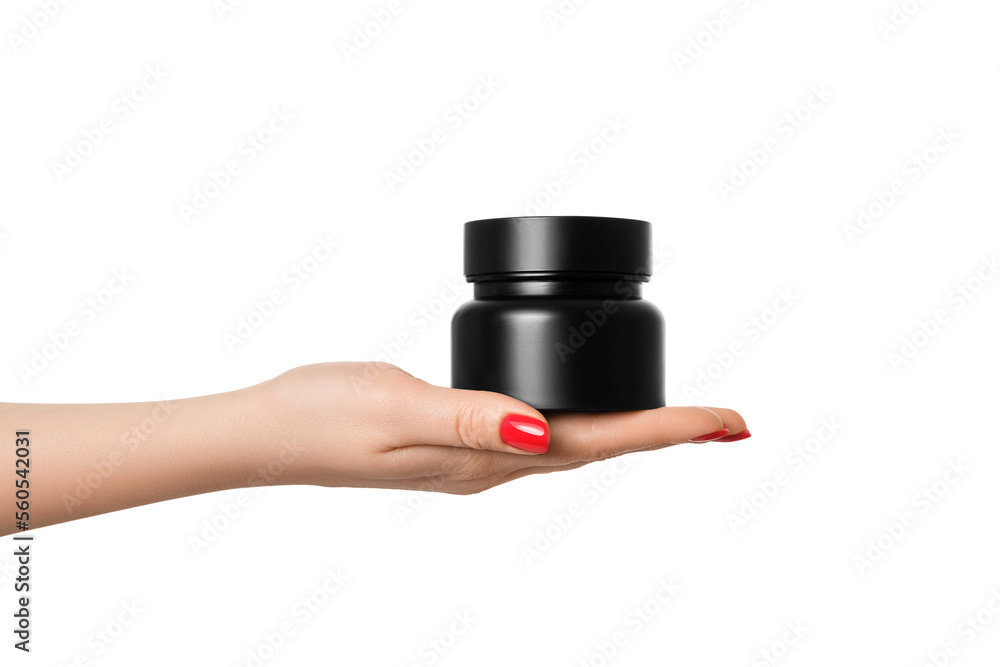 A black jar with a beautiful glare in a female hand with a manicure, on a white background. A black jar with a beautiful glare in a female hand with a manicure, on a white background.