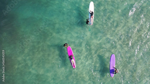 Photography Aerial drone top down photo of surfers having surfing lesson in tropical exotic