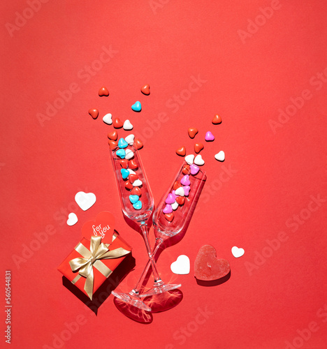 Two Glasses with candy on red background. Holidays concept
