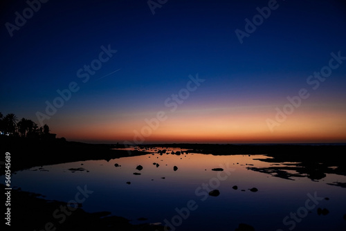 Sea and sun at sunset, orange sunset, blue sea night photo, stars and nature. © MoreThanProd