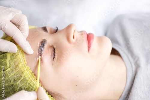 Obraz na plátně beautician applying composition for eyelash lamination to woman close-up