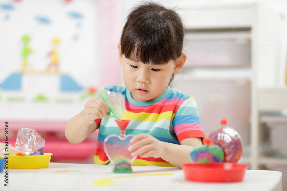 young girl making sand crafts for homeschooling young girl making sand crafts for homeschooling