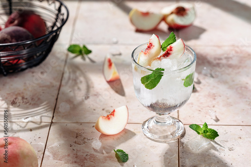 Preparation of a refreshing summer drink from peaches, ice, mint and mineral water